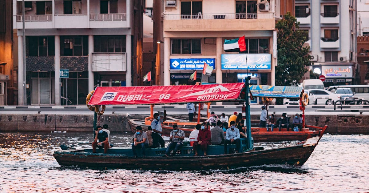 Passengers on a traditional abra crossing Dubai Creek at sunset, one of the top things to do in Dubai