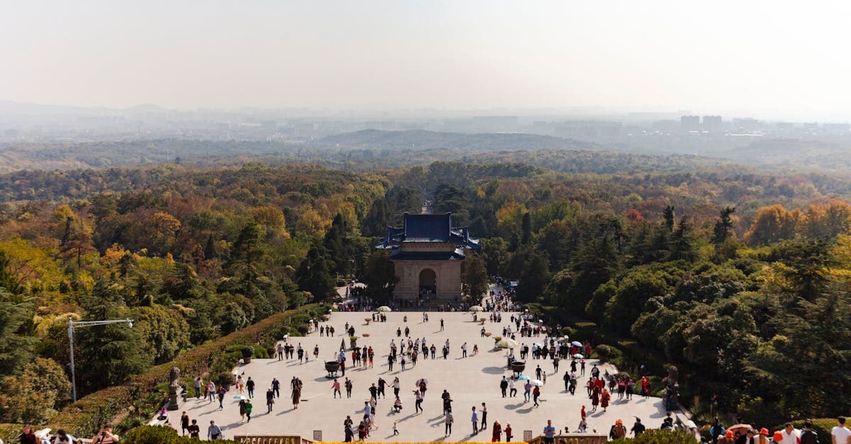 Aerial view of Sun Yat-sen Mausoleum surrounded by lush forest in Nanjing, showcasing an affordable tourist destination
