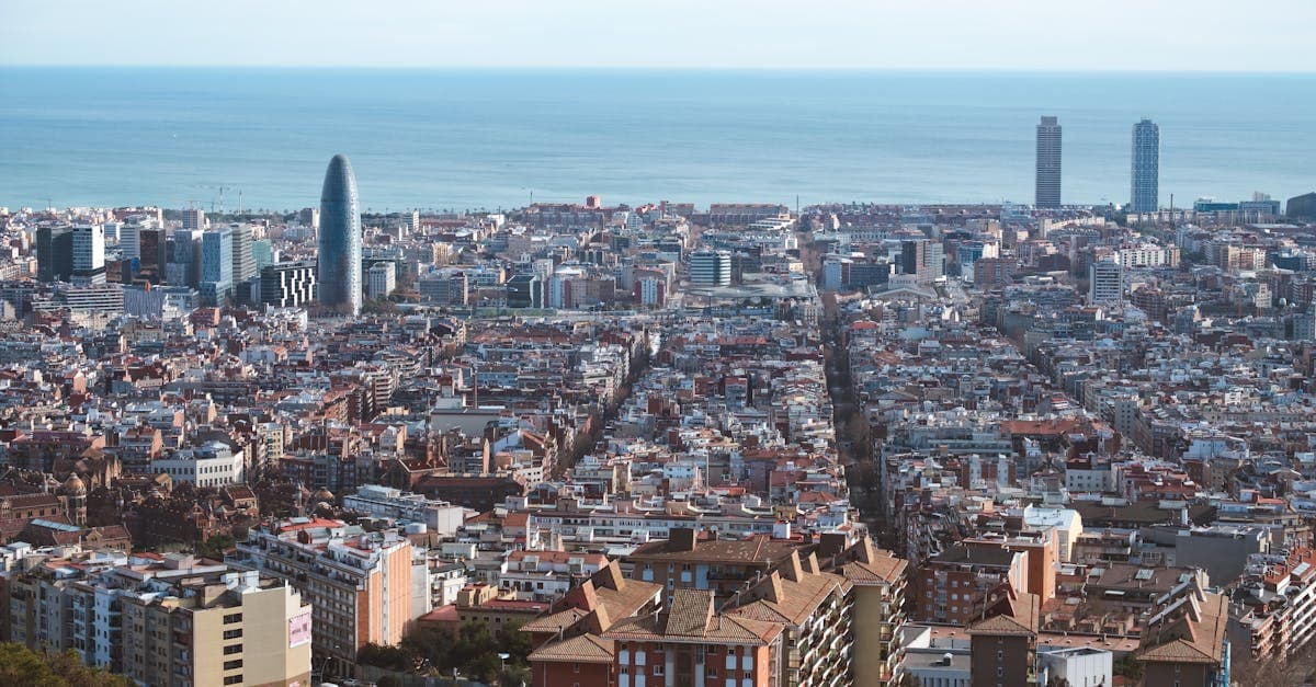 Panoramisch luchtoverzicht van de bezienswaardigheden Barcelona en de Middellandse Zee in de verte.
