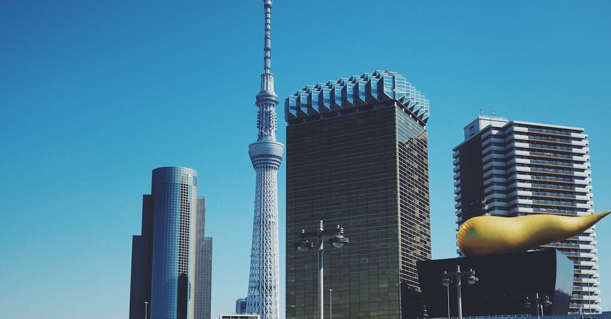 Tokyo Skytree and the Asahi Beer Hall beneath a clear blue sky near Asakusa