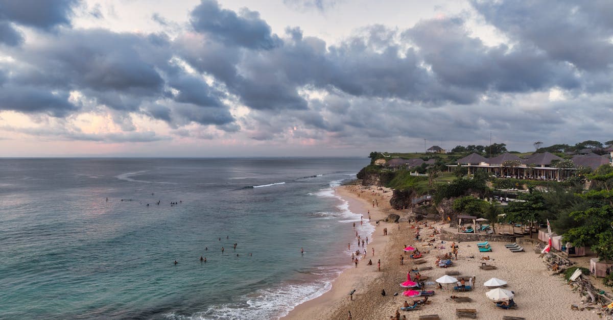Aerial sunset view of Bali's beach with visitors exploring opportunities to work abroad in Bali