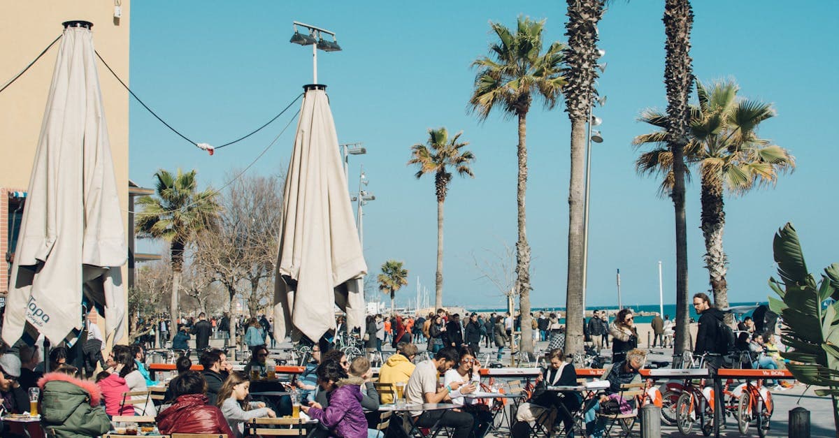 Colourful outdoor café in Barcelona with diners enjoying the sunny atmosphere, perfect for the menú del día