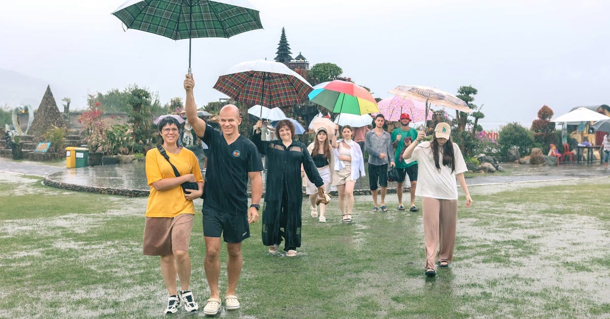 Colorful umbrellas in tropical garden during rainfall demonstrates how monthly bali weather variations impact visitors.