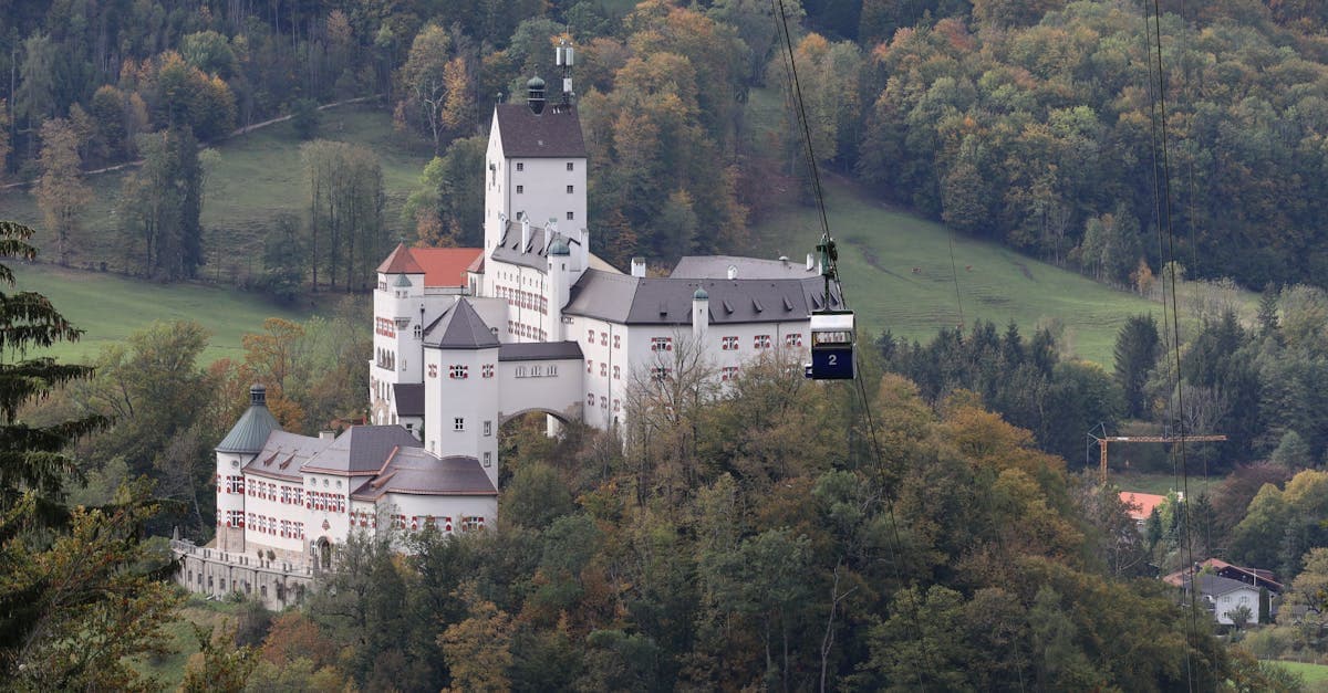 A picturesque castle surrounded by autumn foliage in Aschau im Chiemgau, Bavaria.