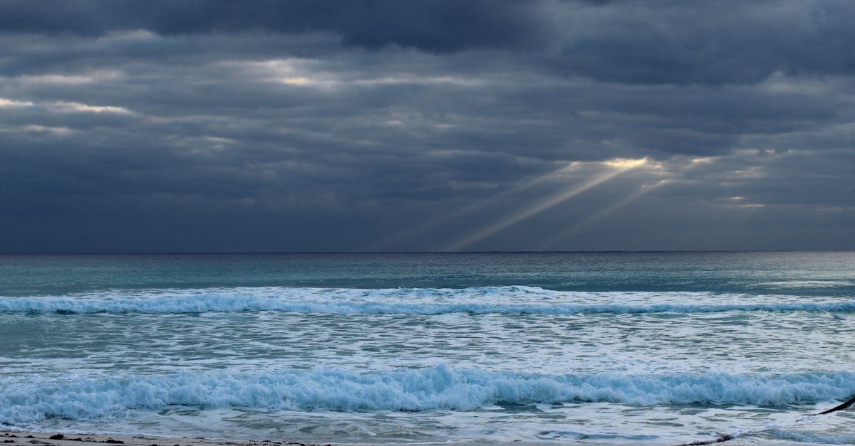 Cancun's ocean and cloudy skies during rainy season, with timing tips for the best time to visit