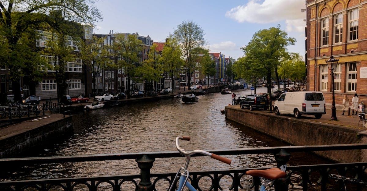 Amsterdam canal on a sunny day with a bicycle and boats, staying connected while exploring the city