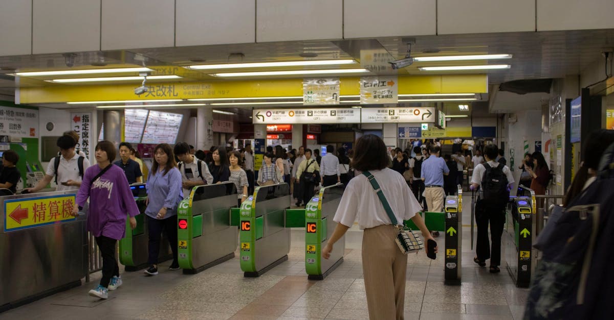 Commuters streaming through Tokyo subway ticket gates, where Apple Pay Suica simplifies city travel