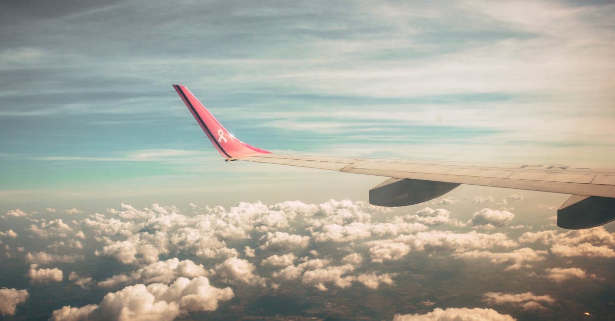 Airplane window view at dawn showing wing and clouds, staying connected when flying from Dublin