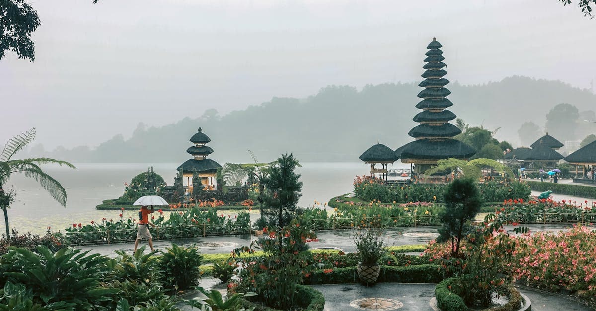 Misty Balinese temple garden with lush tropical growth revealing seasonal bali weather patterns and monsoon influence.