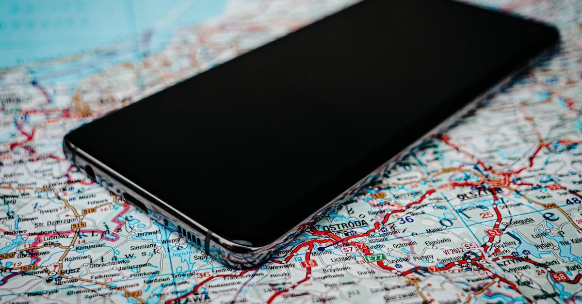 Smartphone placed on a European road map illustrating how mobile roaming charges europe work when travelling