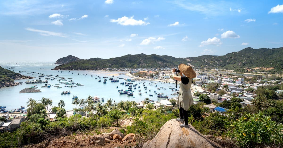 Photographer overlooking serene Vinh Hy Bay, capturing an underrated gem among Asia's cheapest countries to visit.