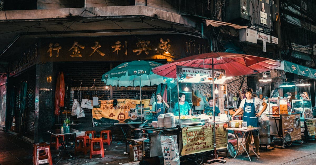 Vibrant Bangkok night market with street food thailand vendors illuminated and bustling with activity.