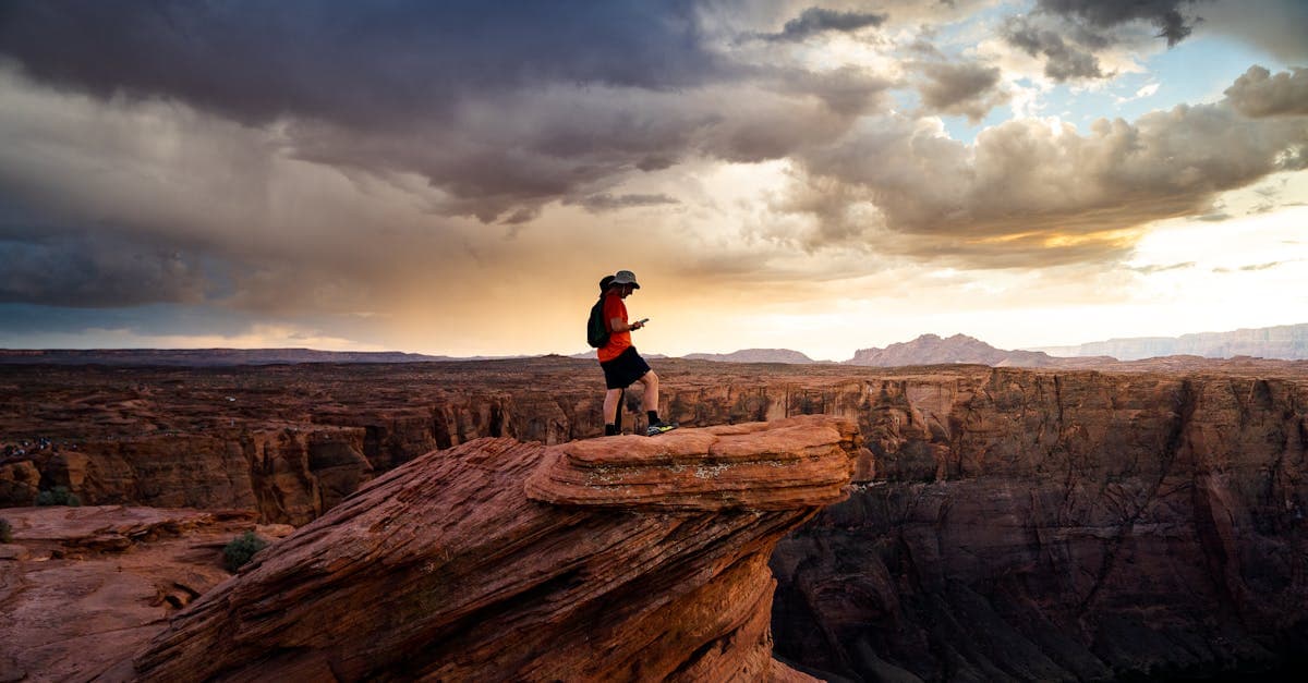 Hiker navigating a scenic Arizona canyon at sunrise, illustrating key solo travel tips at a glance.