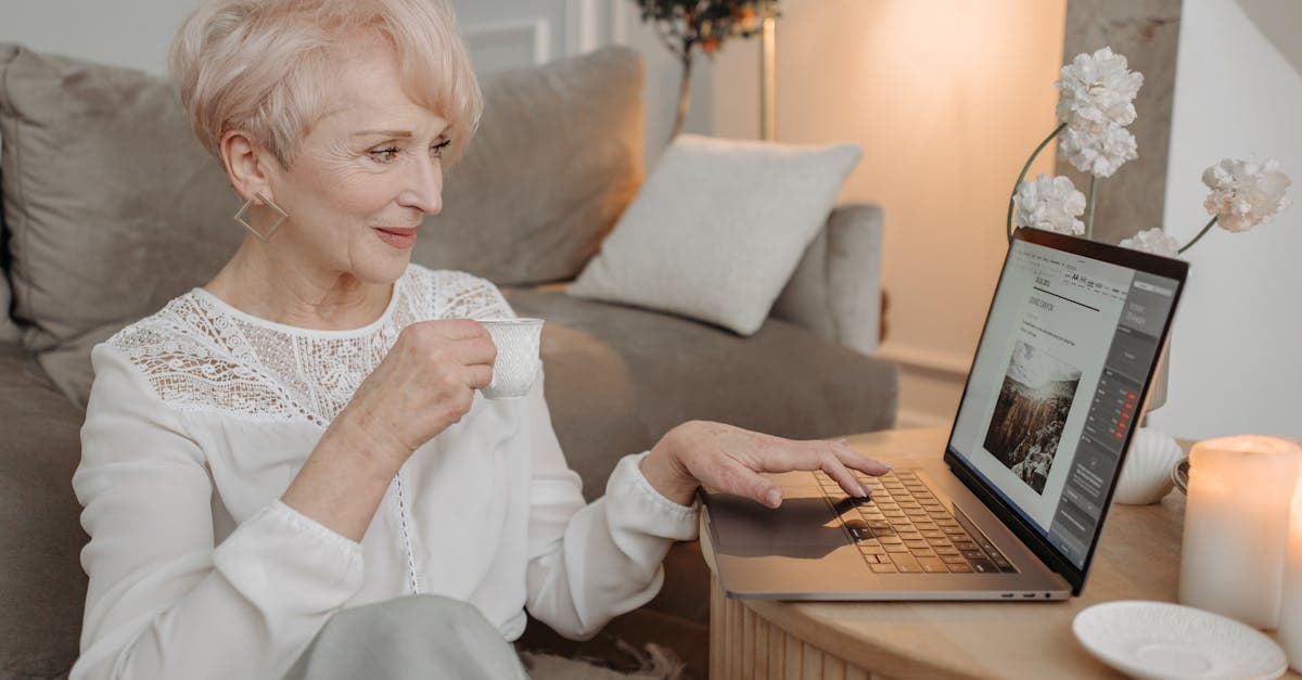 Senior remote professional working comfortably from home on a laptop, enjoying coffee in Ireland.