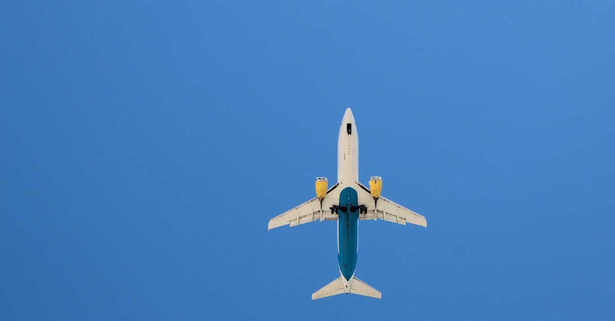 Commercial airplane against clear blue sky — budget airline hidden fees can add up on cheap flights from Singapore.