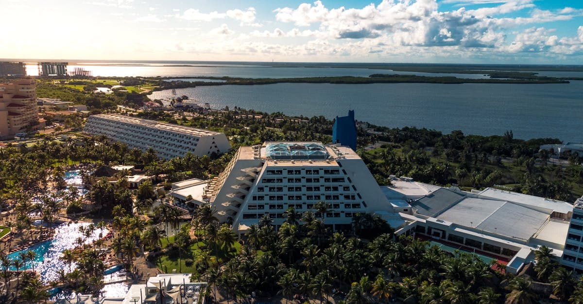Cancun beachfront resort with palm trees and blue Caribbean waters under the US Level 2 travel advisory