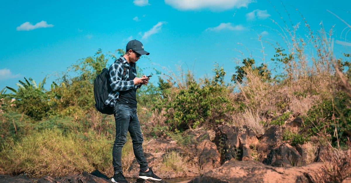 Solo traveller using a travel eSIM on smartphone to stay connected while exploring India's outdoors