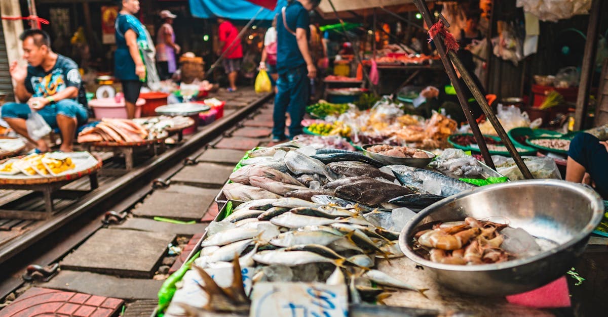 Fresh seafood stalls lining Bangkok's railway market, a hidden street food gem for travellers