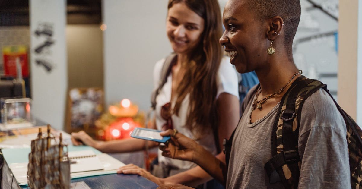 Two travellers checking into a hotel, relying on a regional travel eSIM to stay connected across Southeast Asia.