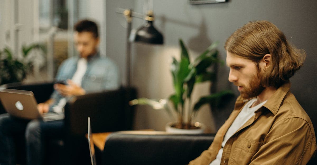 Two professionals on laptops in a modern coworking space staying connected in Singapore