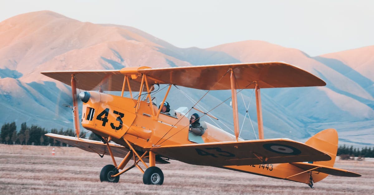 Yellow biplane soaring over New Zealand mountains, symbolising the freedom of affordable travel eSIM connectivity