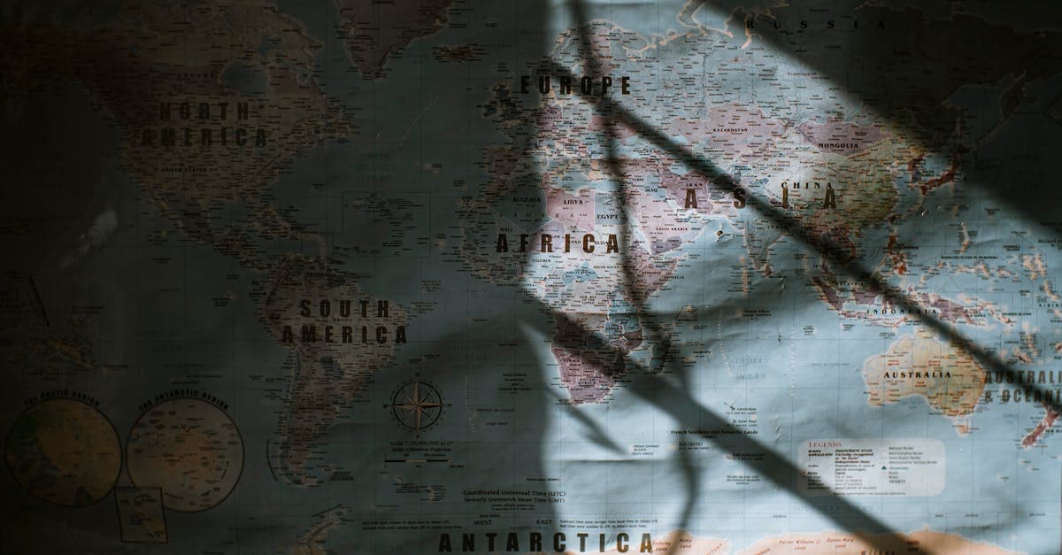 Sunlight casting dramatic shadows across a world map highlighting South Asia and North Africa travel routes