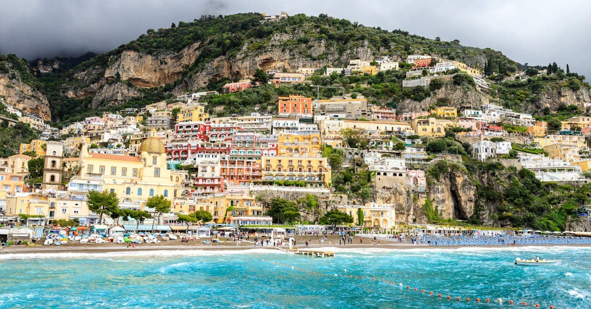 Positano's colourful hillside buildings cascading to the Mediterranean, among Europe's cheapest holiday destinations