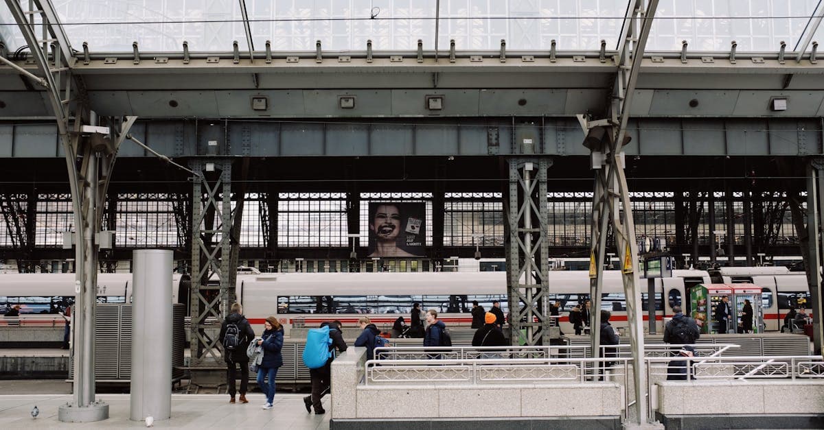 Busy European train station with modern trains, where a travel eSIM helps South Africans avoid costly roaming charges