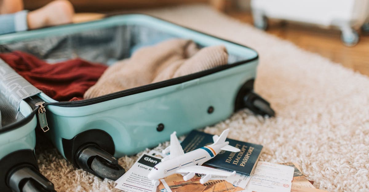 Open carry-on suitcase with passport and tickets for a minimalist packing list travel in New Zealand