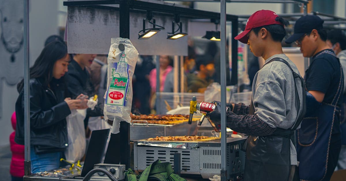 Korean street food vendors selling tteokbokki, hotteok, and other popular Seoul market snacks to eager customers.