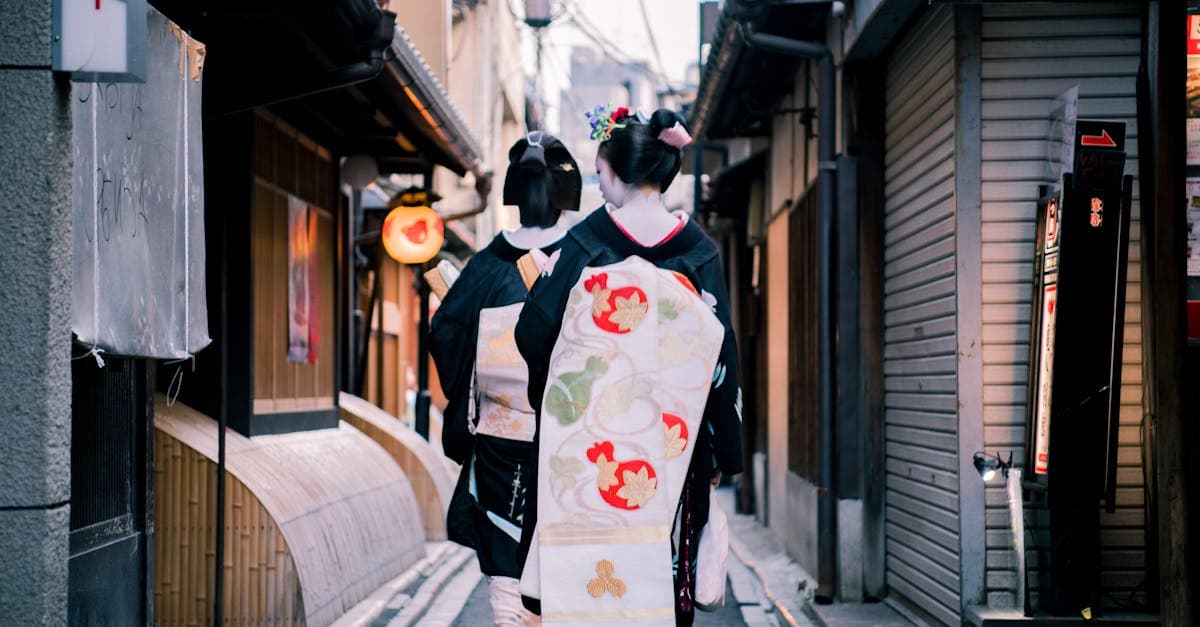 Japanese women in kimonos walking a Kyoto laneway where patchy free WiFi leaves travellers frustrated